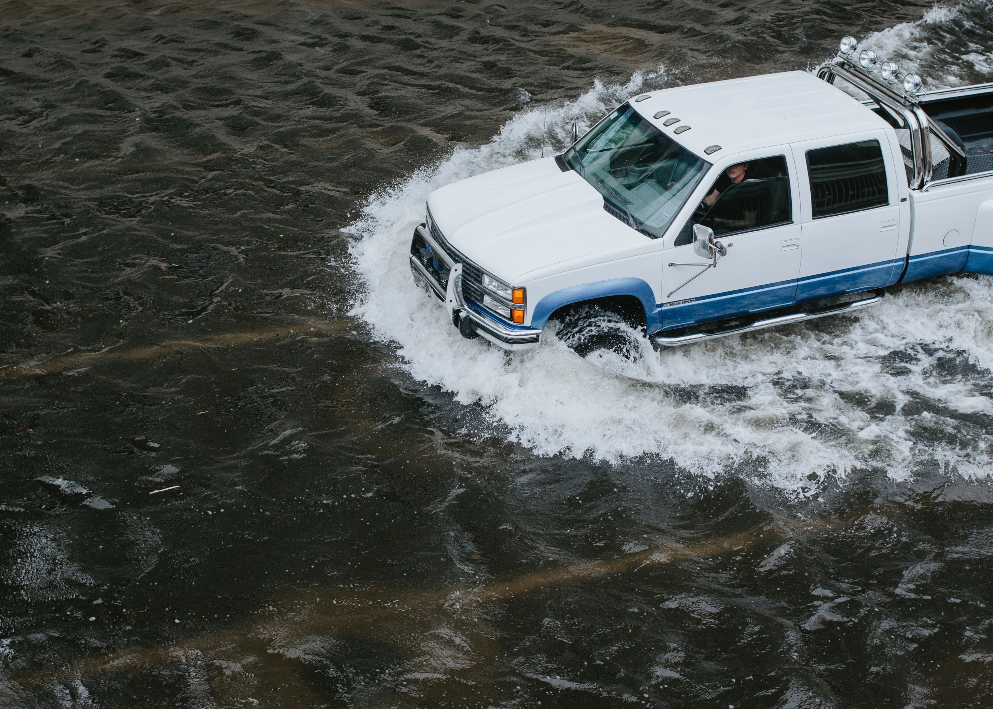 truck driving on flooded street
